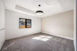 Step into this bright and airy room, featuring a modern design with neutral tones and a plush carpet.