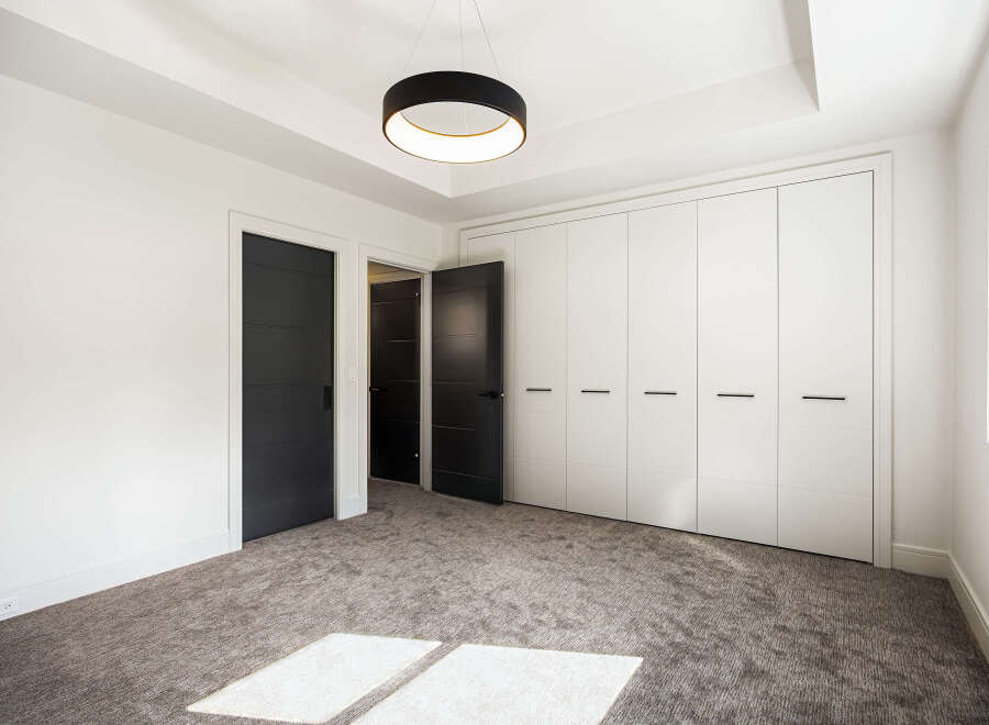 Step into modern elegance with this stunning property, featuring a spacious bedroom with ample natural light.