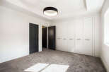 Step into modern elegance with this stunning property, featuring a spacious bedroom with ample natural light.