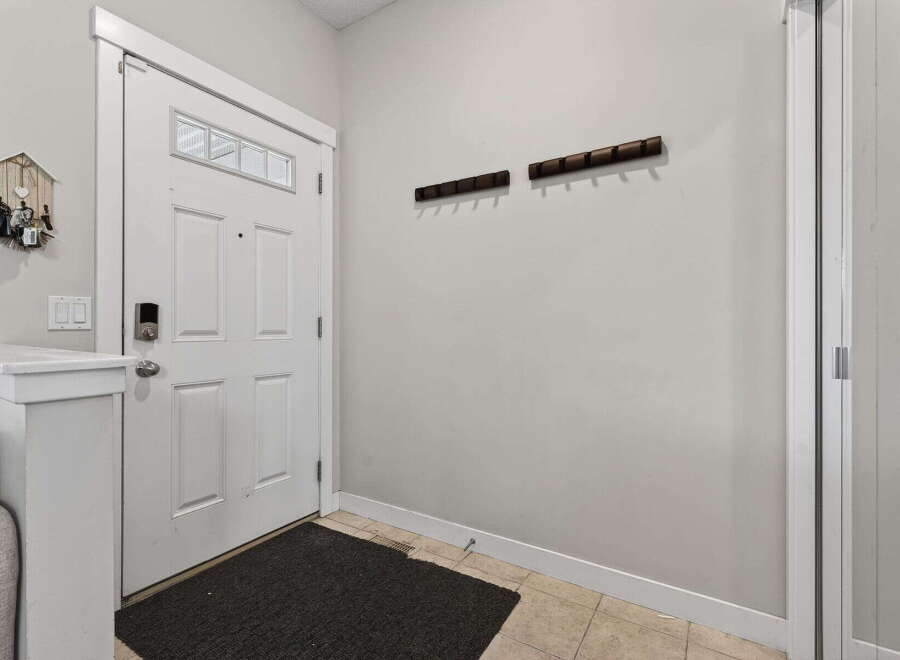 Step into this inviting entryway, showcasing a modern design with a touch of warmth.