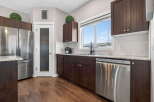 Step into this stunning kitchen, boasting rich, dark cabinetry and sleek stainless steel appliances.