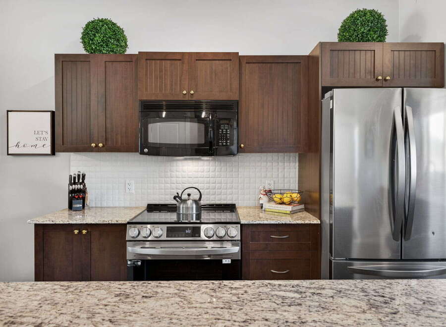 This stunning kitchen boasts modern appliances and elegant cabinetry, perfect for culinary enthusiasts.