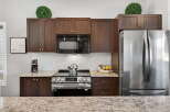 This stunning kitchen boasts modern appliances and elegant cabinetry, perfect for culinary enthusiasts.