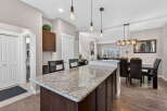 This stunning kitchen boasts a spacious island with granite countertops, perfect for meal prep and entertaining.