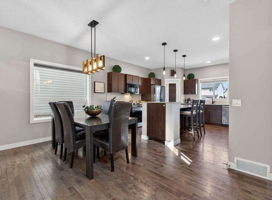 Step into this stunning home featuring a modern kitchen and dining area.