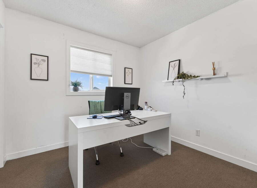 This bright and airy home office features a modern white desk, perfect for productivity.