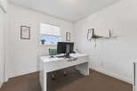 This bright and airy home office features a modern white desk, perfect for productivity.
