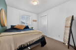 Step into this inviting bedroom, featuring a cozy bed adorned with plush pillows and a stylish throw.