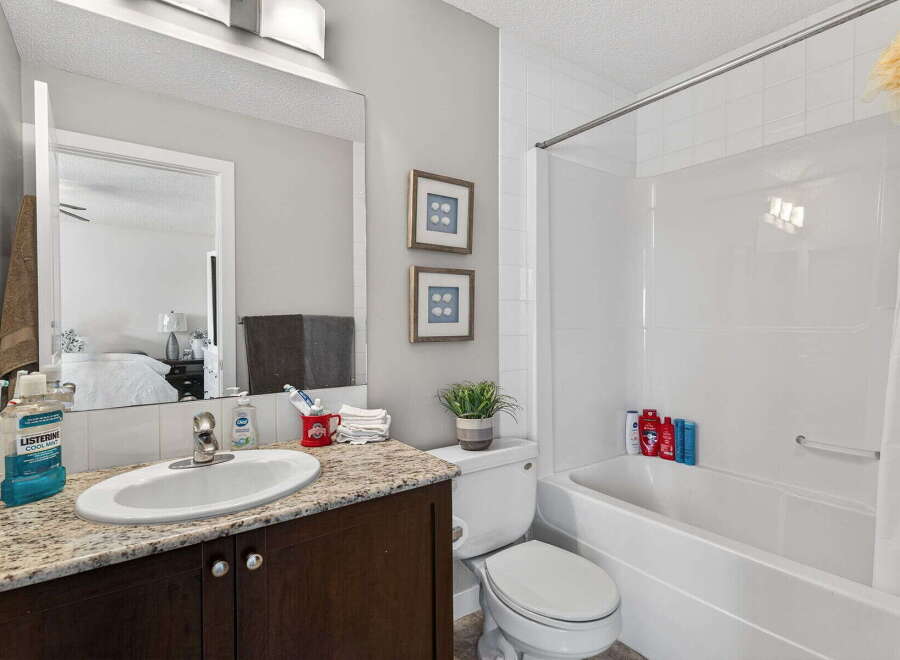 Step into a beautifully designed bathroom featuring a modern vanity with a stylish countertop and a sleek sink.