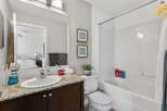 Step into a beautifully designed bathroom featuring a modern vanity with a stylish countertop and a sleek sink.