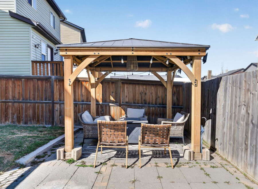 Enjoy outdoor living in this stunning backyard oasis! This property features a beautiful gazebo, perfect for entertaining or relaxing.