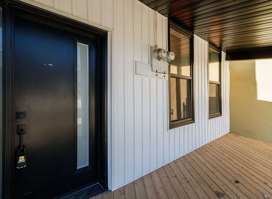 Discover this charming property featuring a modern black front door with a glass panel, offering a stylish entrance.