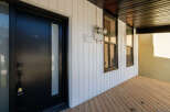 Discover this charming property featuring a modern black front door with a glass panel, offering a stylish entrance.