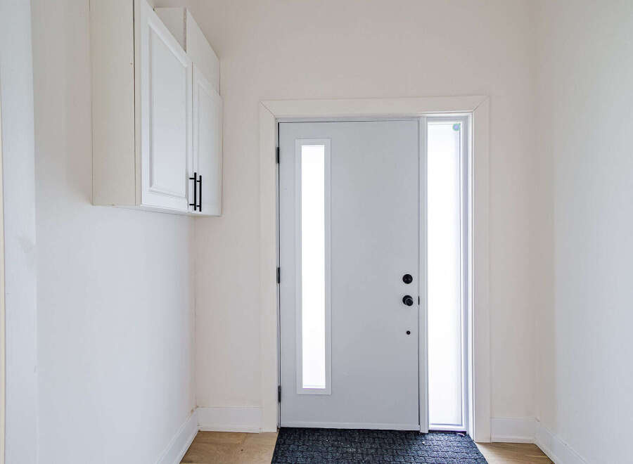 Step into modern elegance with this stunning entryway! Featuring a sleek, white door with a glass panel, this space is bathed in natural light.