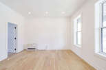 This bright and airy room features beautiful hardwood floors and crisp white walls, creating a clean and inviting atmosphere.