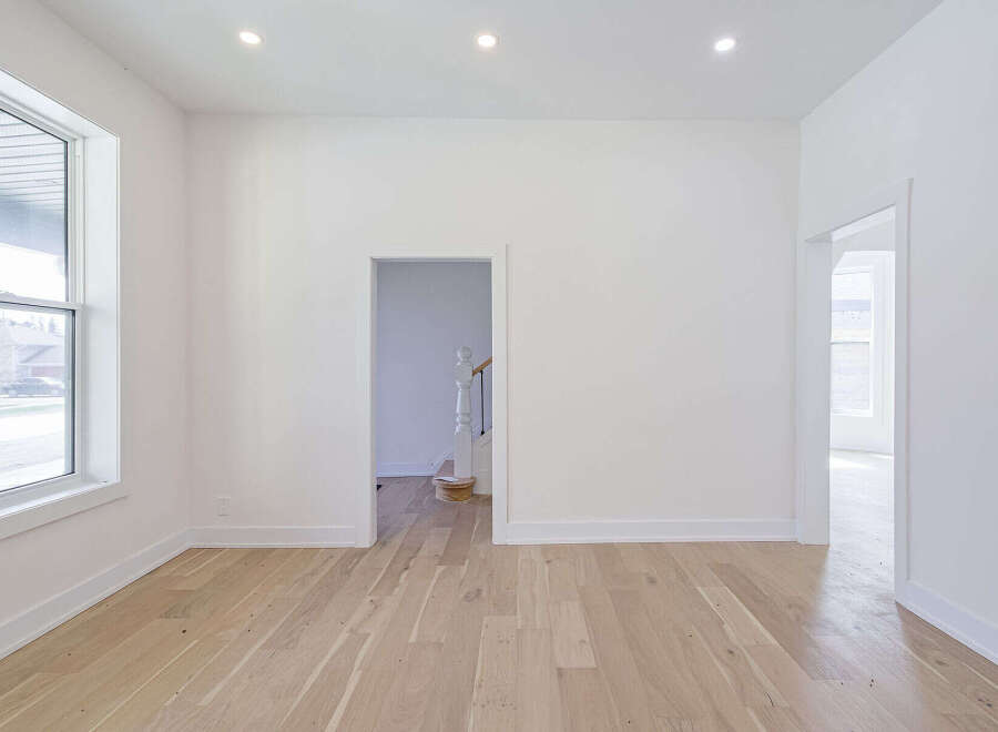 Step into this bright and airy space, featuring pristine white walls and elegant hardwood floors.