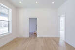 Step into this bright and airy space, featuring pristine white walls and elegant hardwood floors.