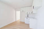 This stunning property boasts a modern kitchen with sleek white cabinetry and a stylish countertop.