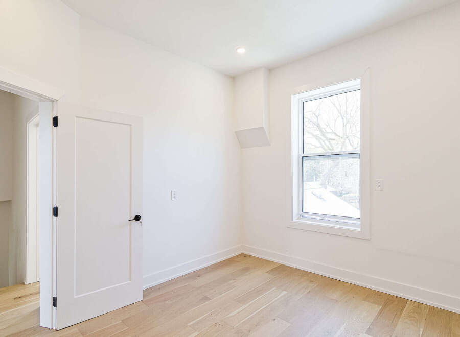 Step into this bright and airy room, featuring pristine white walls and elegant hardwood floors.