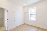Step into this bright and airy room, featuring pristine white walls and elegant hardwood floors.