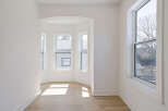 Step into this bright and airy space, featuring a unique bay window design that floods the room with natural light.