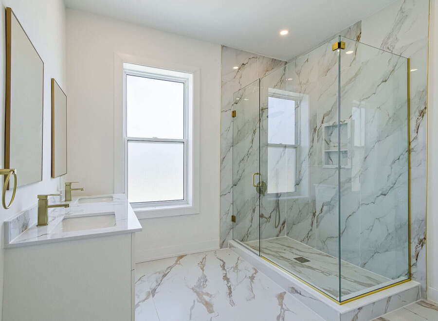 Step into luxury with this stunning bathroom featuring a spacious glass-enclosed shower and elegant marble accents.