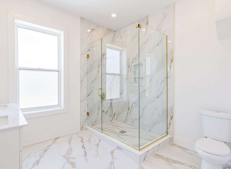 Step into luxury with this stunning bathroom featuring a modern glass shower enclosure.