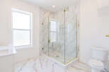 Step into luxury with this stunning bathroom featuring a modern glass shower enclosure.