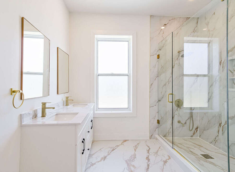 Step into luxury with this stunning bathroom featuring a sleek, modern design.