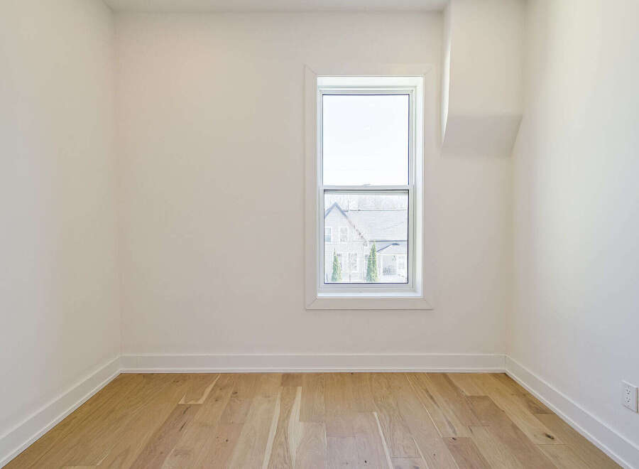 This bright and airy room features beautiful hardwood floors and crisp white walls, creating a clean and inviting atmosphere.