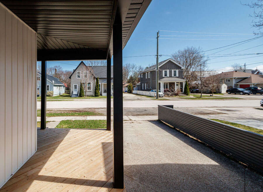 Discover the charm of this beautifully designed property, featuring a welcoming porch and a modern aesthetic.