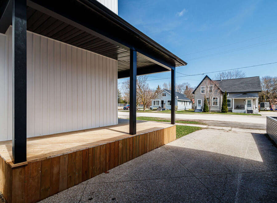 This stunning property boasts a modern design with a welcoming porch, perfect for enjoying the outdoors.