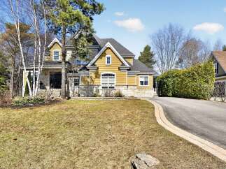 This stunning property boasts a beautiful exterior with a combination of stone and yellow siding, creating a warm and inviting curb appeal.