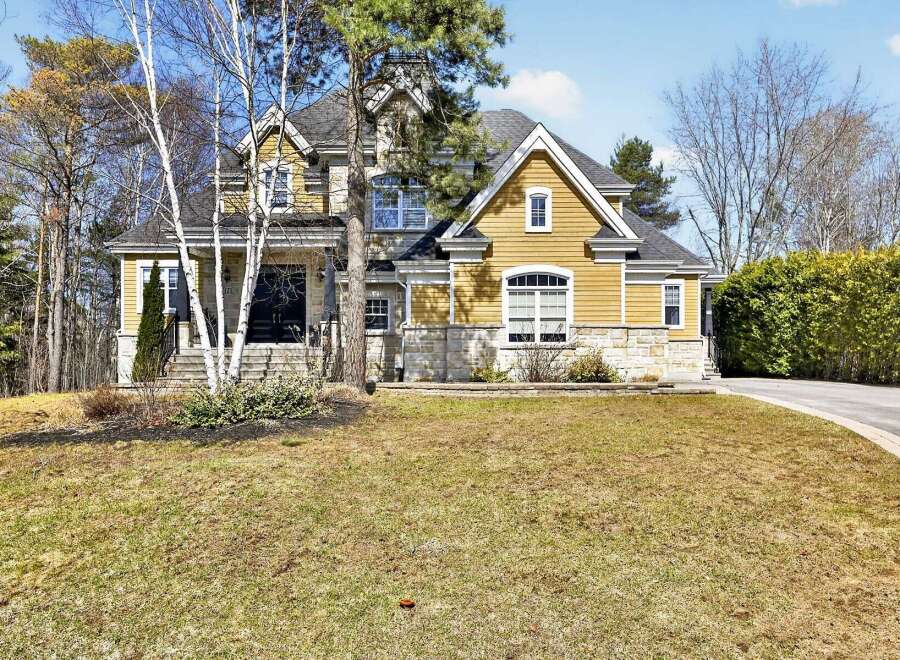 This stunning property boasts a beautiful exterior with a combination of stone and siding, creating a timeless appeal.
