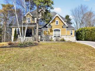 This stunning property boasts a beautiful exterior with a combination of stone and siding, creating a timeless appeal.