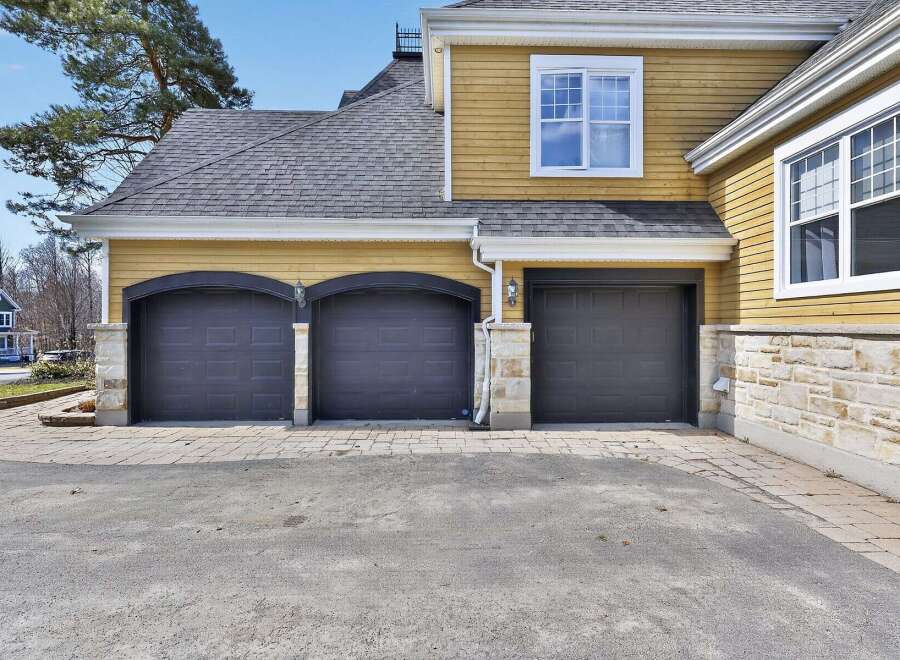 This stunning property boasts a beautiful exterior with a multi-car garage, perfect for families or car enthusiasts.