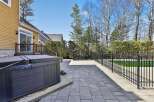Enjoy luxurious outdoor living with this stunning property featuring a spacious patio and a relaxing hot tub.