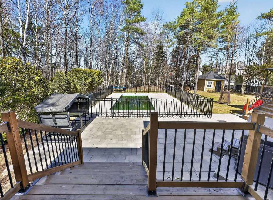 Enjoy luxurious outdoor living with this stunning property featuring a private pool and a spacious deck.