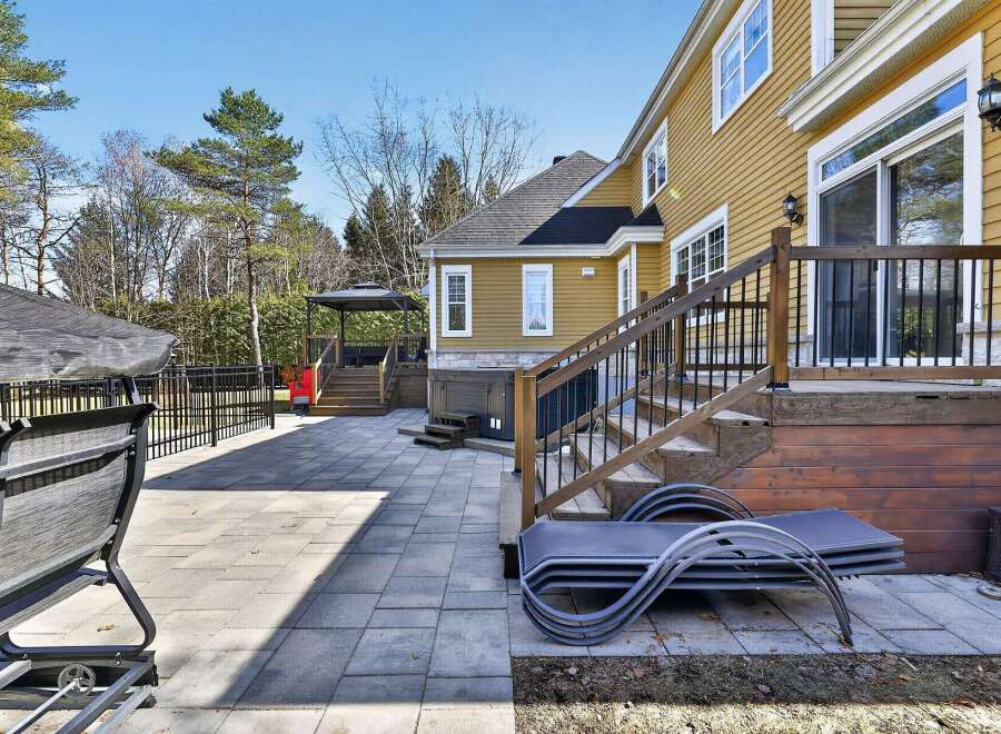 Enjoy outdoor living at its finest with this stunning property featuring a spacious patio and a beautifully designed deck.