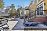 Enjoy outdoor living at its finest with this stunning property featuring a spacious patio and a beautifully designed deck.