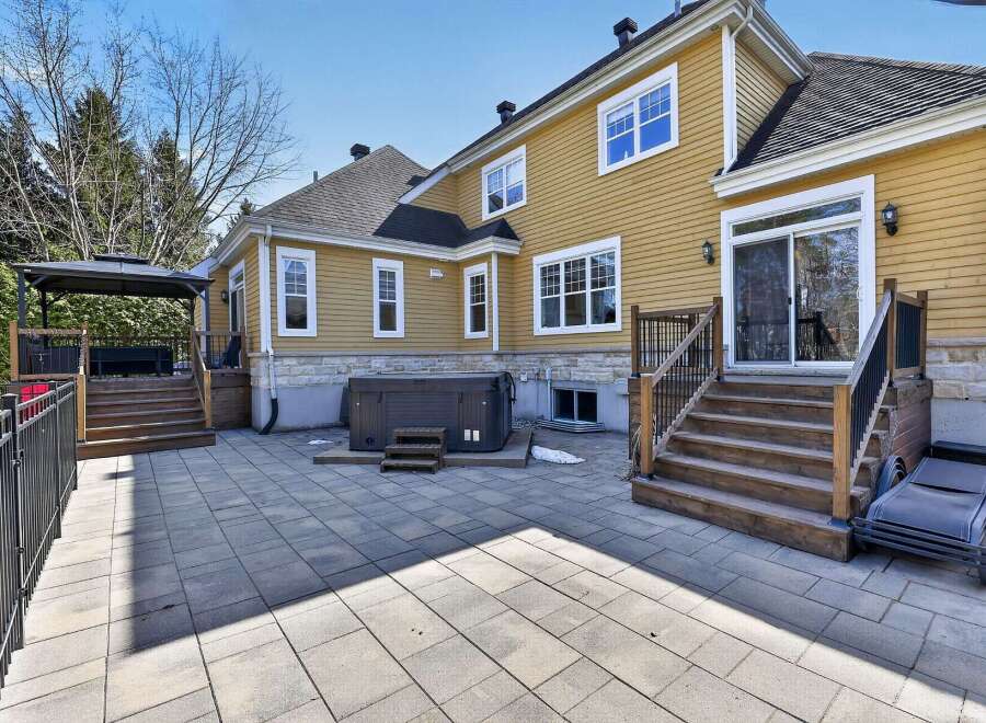 Enjoy outdoor living at its finest with this stunning property featuring a spacious patio and a luxurious hot tub.