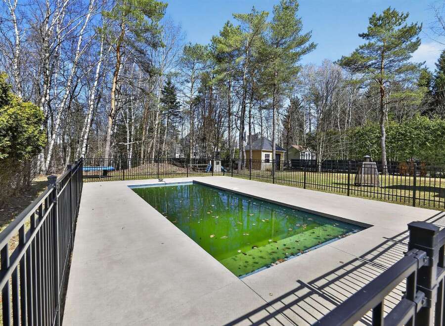 Discover the tranquility of this stunning property featuring a pristine swimming pool, perfect for relaxation and entertainment.