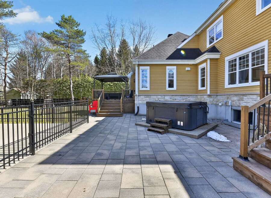 Enjoy outdoor living at its finest with this stunning property featuring a spacious patio and a luxurious hot tub.