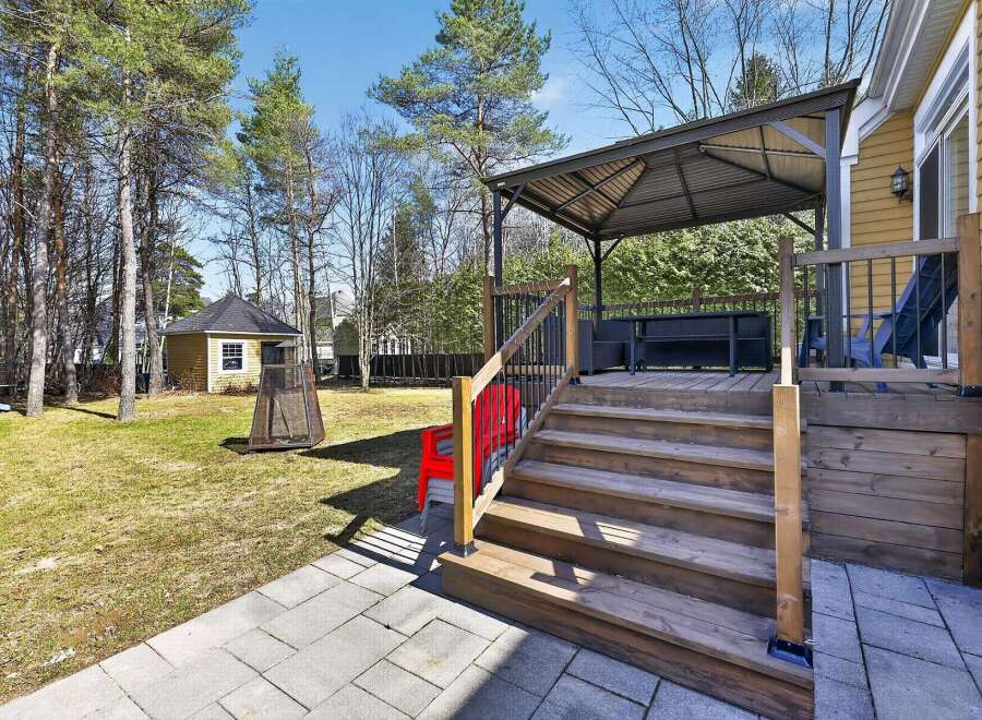 Enjoy outdoor living at its finest with this stunning property featuring a spacious deck and a charming gazebo.