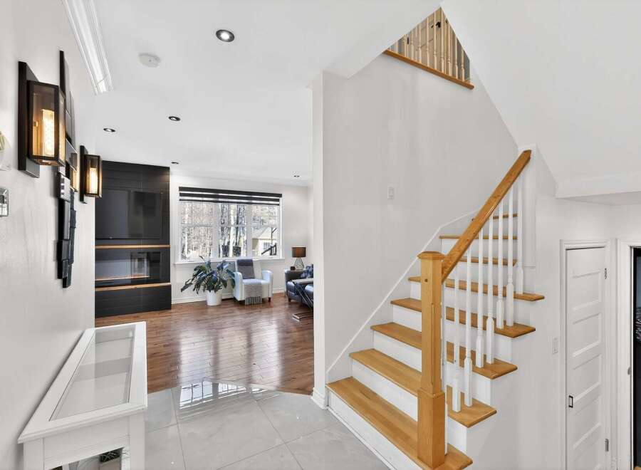 Step into luxury with this stunning property featuring a grand staircase and modern design.