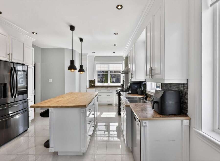 Step into this stunning kitchen, boasting a sleek, modern design with ample storage and counter space.