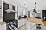 Step into this stunning kitchen, featuring sleek stainless steel appliances and a modern design.