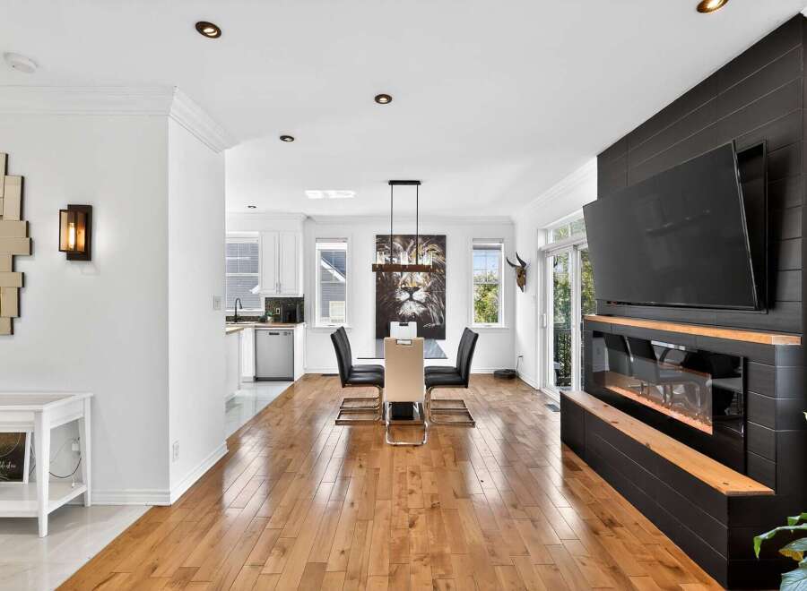 This stunning property boasts a modern interior with hardwood floors and a sleek fireplace.