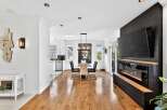 This stunning property boasts a modern interior with hardwood floors and a sleek fireplace.
