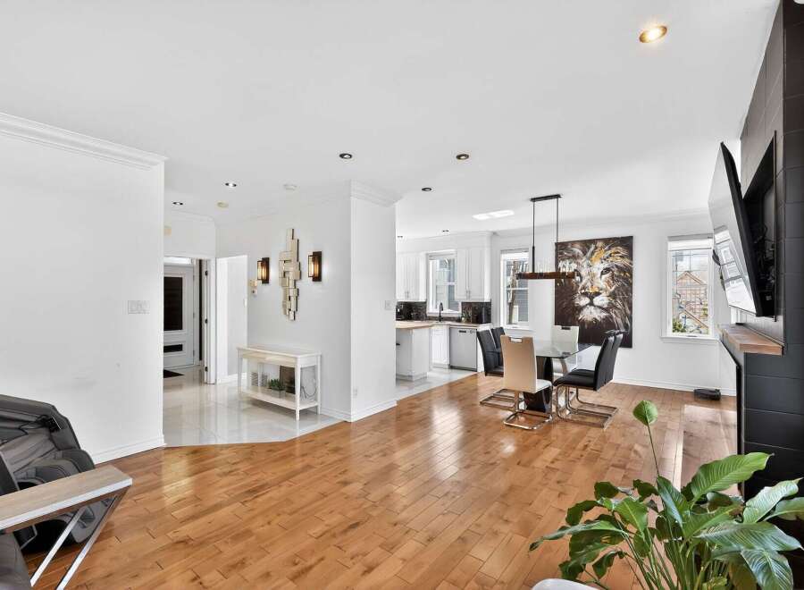 Step into luxury with this stunning property, featuring a bright and airy living space with beautiful hardwood floors.